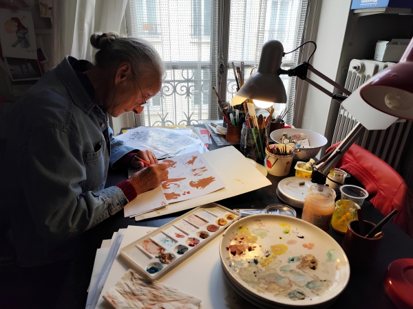 Dans l’atelier d’Evelyne Tranlé, coloriste de Valérian, Blueberry et Philémon Evelyne Tranlé au travail dans son atelier parisien, devant sa table à dessin